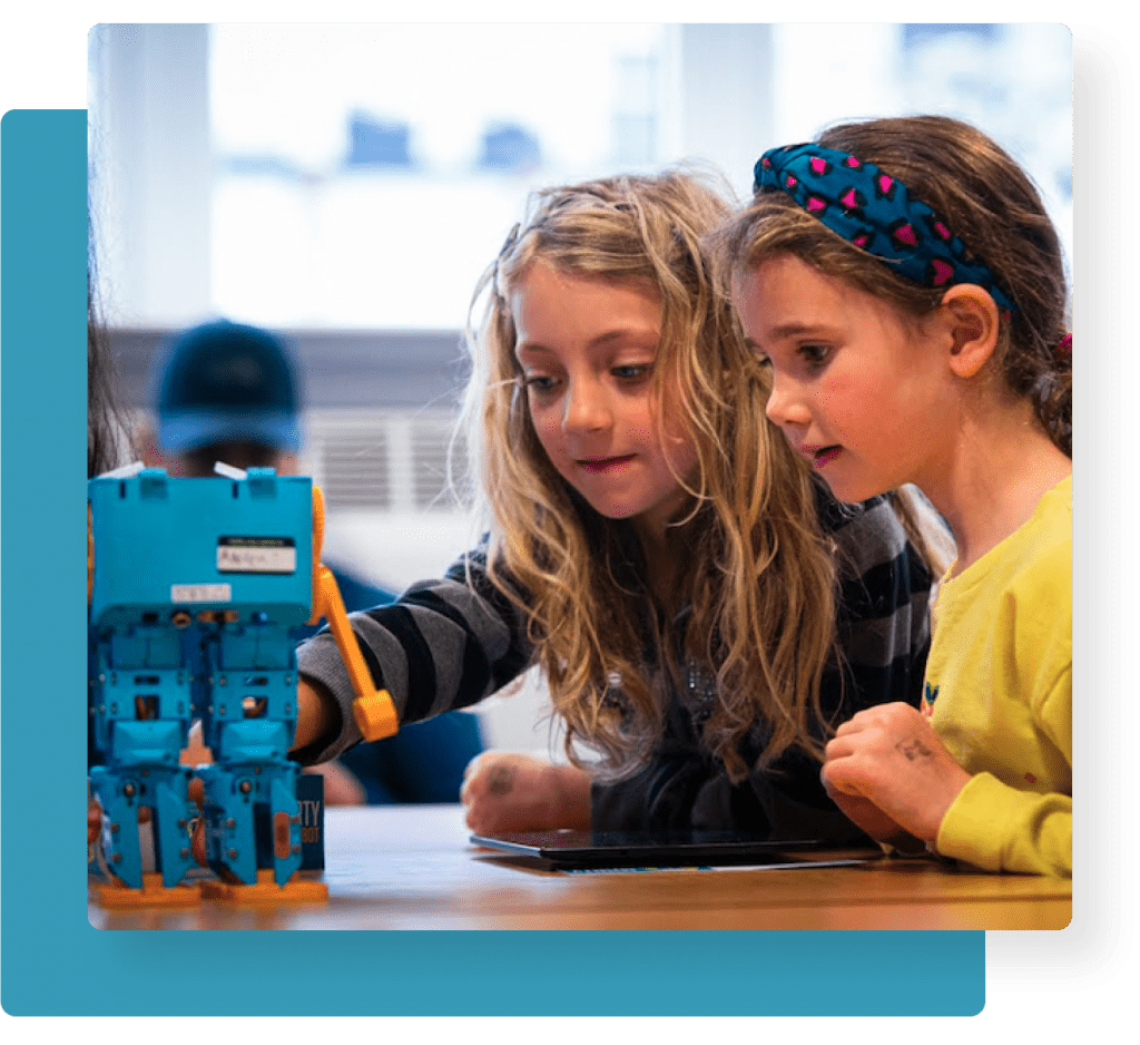 Two students learning with Marty the Robot
