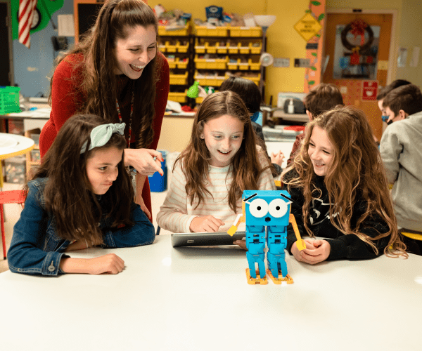 Three girls learning programming through Marty the Robot